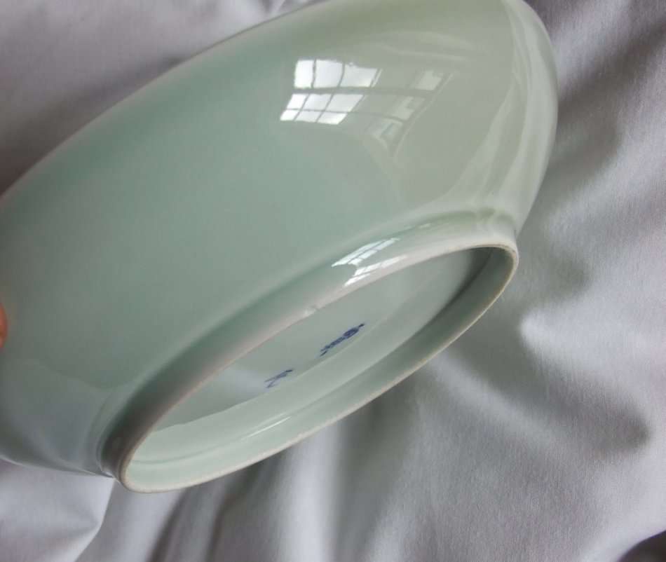 An old Chinese Celadon bowl with chrysanthemum embossing