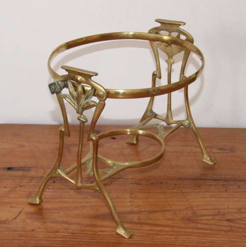 Art Nouveau brass warmer stand with hinged holder.