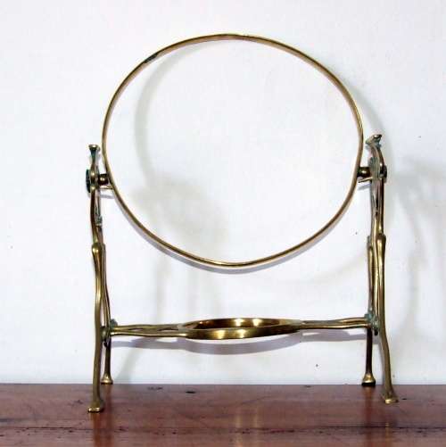 Art Nouveau brass warmer stand with hinged holder.