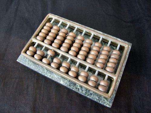 Vintage desktop Chinese brass abacus on green marble base.
