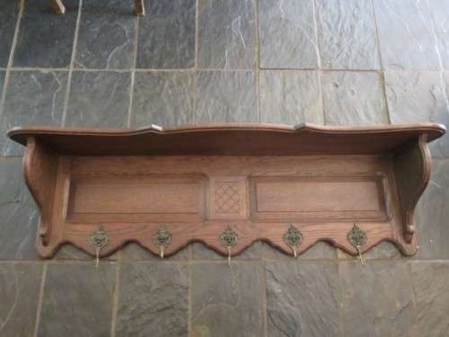 Vintage wood and metal wall mounted coat rack.