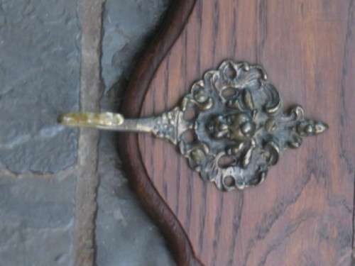 Vintage wood and metal wall mounted coat rack.