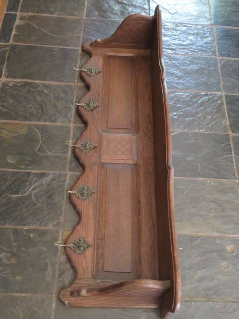 Vintage wood and metal wall mounted coat rack.