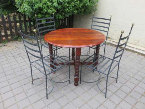 4 heavy wrought iron chairs.