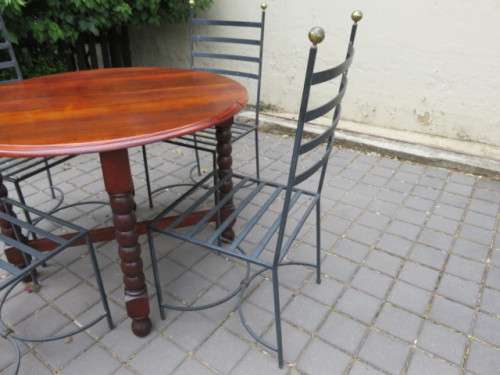 4 heavy wrought iron chairs.