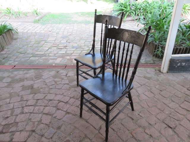 A pair of early 20th century carved oak spindle-back chairs.