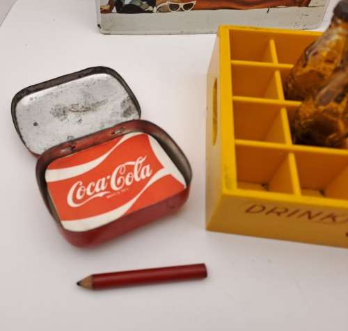 4 Vintage Coca Cola Items. Miniture Crate with 7 Coke bottles, 2 Metal Postcards and note Tin