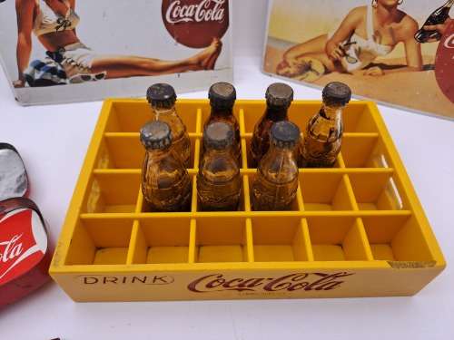 4 Vintage Coca Cola Items. Miniture Crate with 7 Coke bottles, 2 Metal Postcards and note Tin