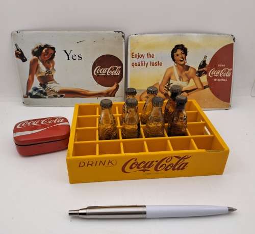 4 Vintage Coca Cola Items. Miniture Crate with 7 Coke bottles, 2 Metal Postcards and note Tin