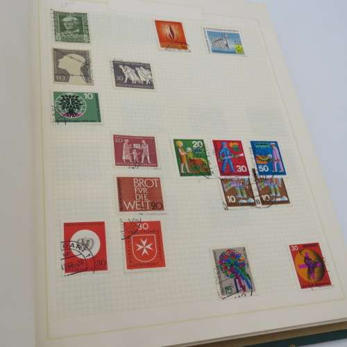 Stamp album with over 1400 stamps including South Africa, China, Switzerland, Britain ect