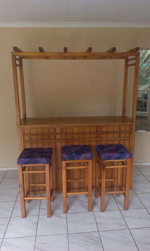 Wooden bar with barstools