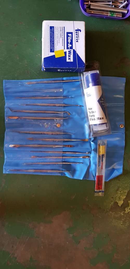 A box full of Jewellery tools Including metal roller and torches.