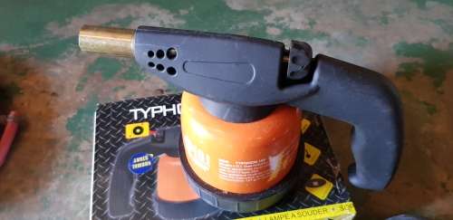 A box full of Jewellery tools Including metal roller and torches.