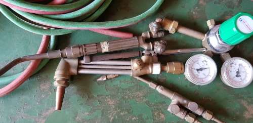 A box full of Jewellery tools Including metal roller and torches.