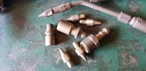 A box full of Jewellery tools Including metal roller and torches.