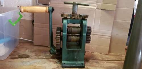 A box full of Jewellery tools Including metal roller and torches.