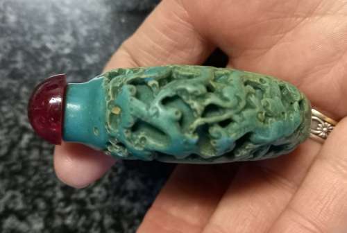 Turquoise coloured snuff bottle with red lid