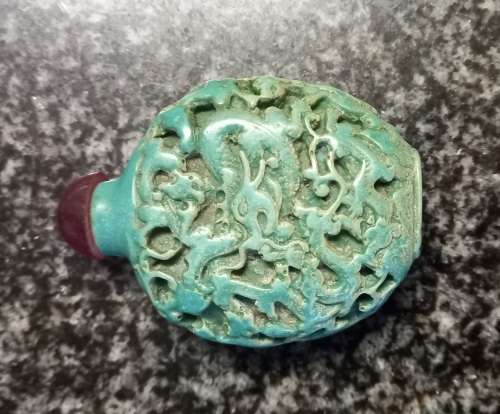Turquoise coloured snuff bottle with red lid