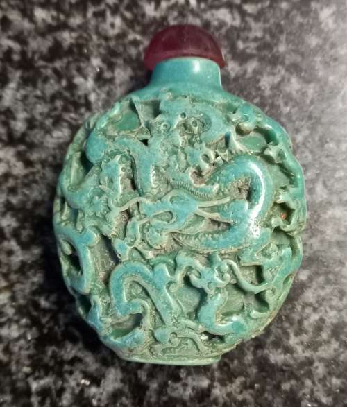 Turquoise coloured snuff bottle with red lid