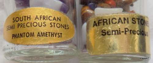 Two bottles with small semi precious stones, and 1 large polished stone.