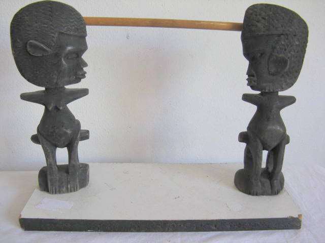 TWO CARVINGS : 21.5cm HIGH : MOUNTED ON A WHITE CHIPBOARD BASE