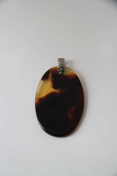 Tortoise shell pendant with sterling silver floral inlay