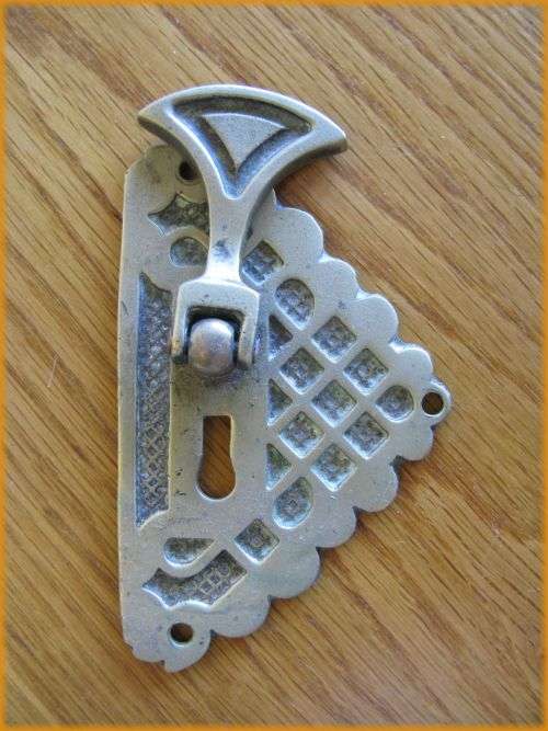 Brass keyhole cover.