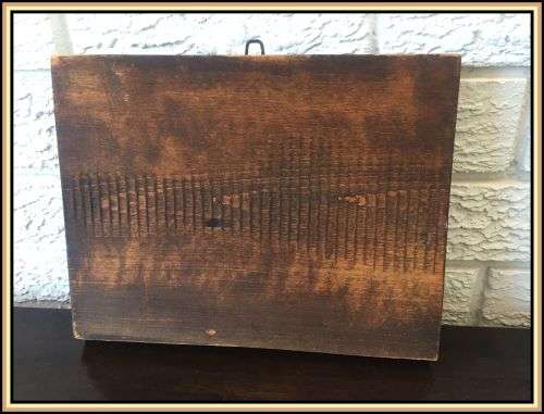 A wooden hand carved wall hanging. A pub scene