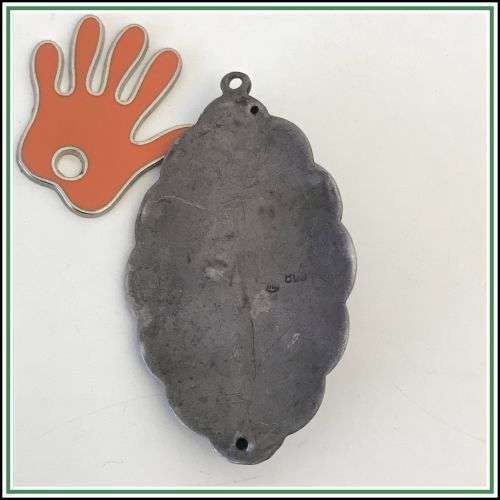 Antique silver repousse pendant with a green stone.