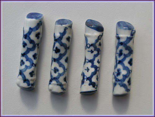 4 hand painted ceramic rests for knives or chopsticks.