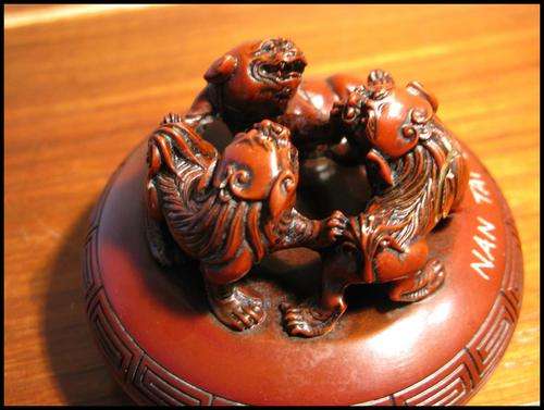 Japanese ink pad box with 3 circling lions.