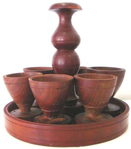 A Set of 6 Hand Turned Wooden Egg Cups on a Stand