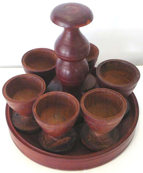 A Set of 6 Hand Turned Wooden Egg Cups on a Stand