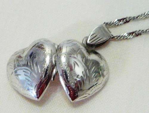 A Beautiful Sterling Silver Heart Shaped Locket and Chain