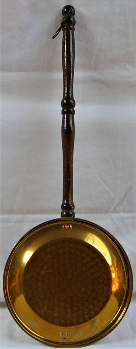 A Brass Bed Warmer With Wooden Handle