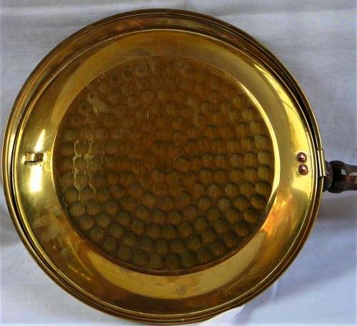 A Brass Bed Warmer With Wooden Handle