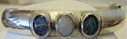 A Very Tasteful Sterling Silver Bangle set with a White Opal & 2 Precious Opals