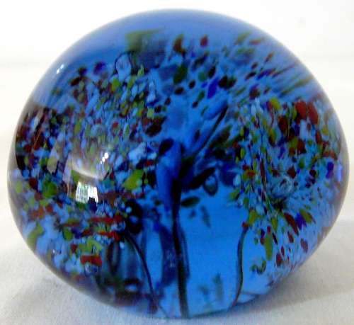 A Dark Blue Glass Paperweight with 3 Multi Coloured Flowers