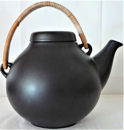 An Elegant Black Oriental Style Tea Pot with a Cane/Rattan Handle