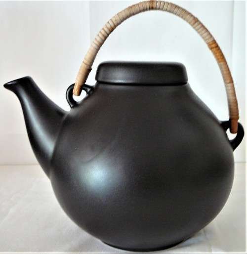 An Elegant Black Oriental Style Tea Pot with a Cane/Rattan Handle