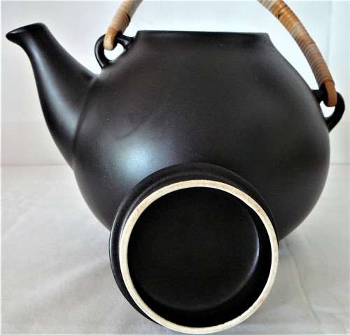 An Elegant Black Oriental Style Tea Pot with a Cane/Rattan Handle