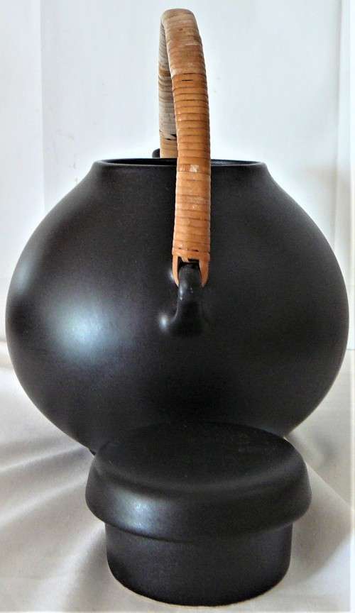 An Elegant Black Oriental Style Tea Pot with a Cane/Rattan Handle