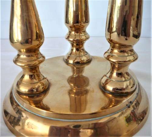 A Solid Brass Triple Candle Holder on a Round Base