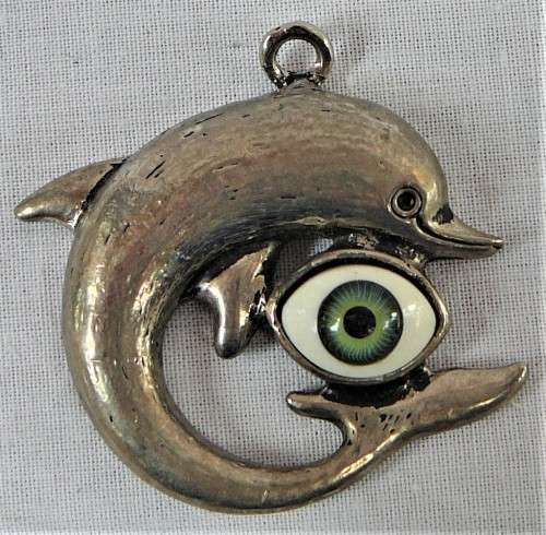 A Silver Coloured Dolphin Pendant with an Eyeball