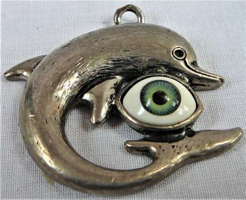 A Silver Coloured Dolphin Pendant with an Eyeball