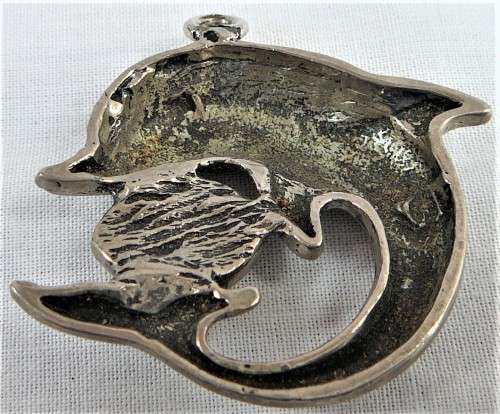 A Silver Coloured Dolphin Pendant with an Eyeball