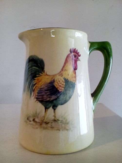 Heron cross pottery milk guy with rooster decoration . Can combine postage.