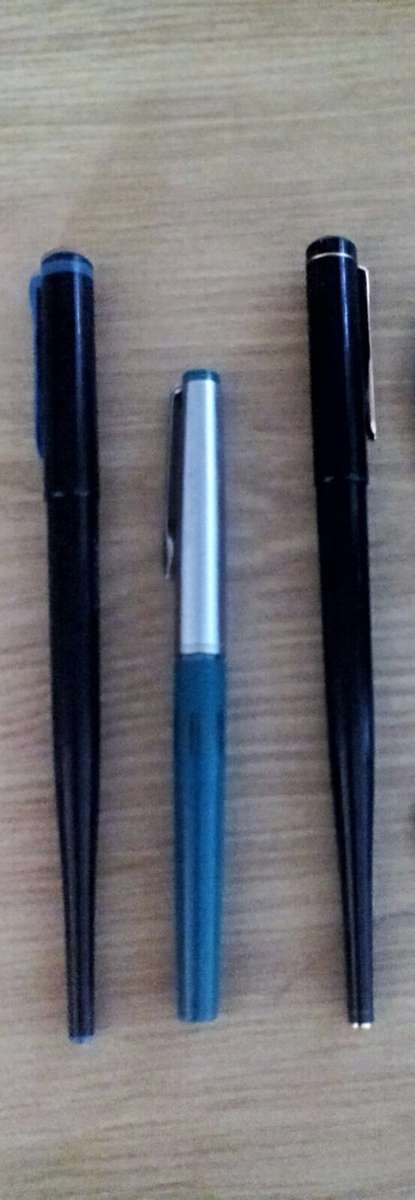 Three fountain pens, two Pelikan and one Geha.