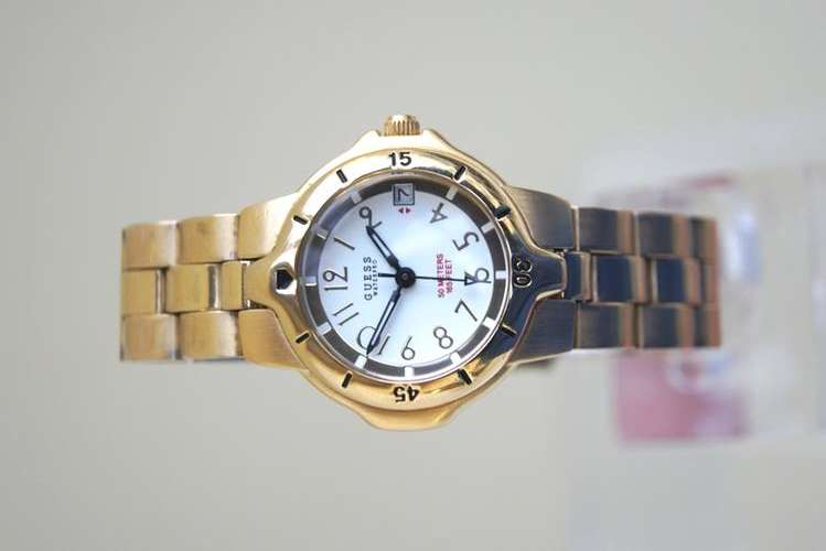 GUESS LADIES WATCH, GOLD PLATED , WHITE DIAL