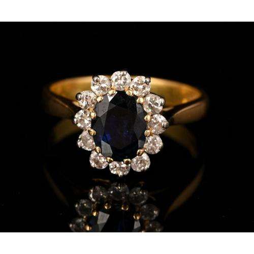 A bespoke 18K yellow & white gold , with oval-cut sapphire ,surround with Diamonds  -halo ring
